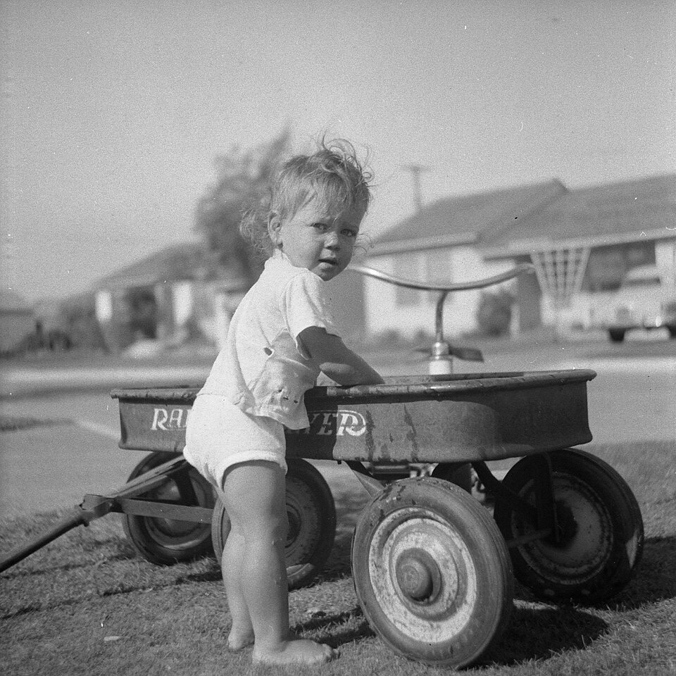 Toddler with Radio Flyer, Lakewood, 1950s
