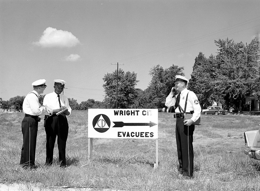 Officials overseeing evacuation sign, Wright City, 1956