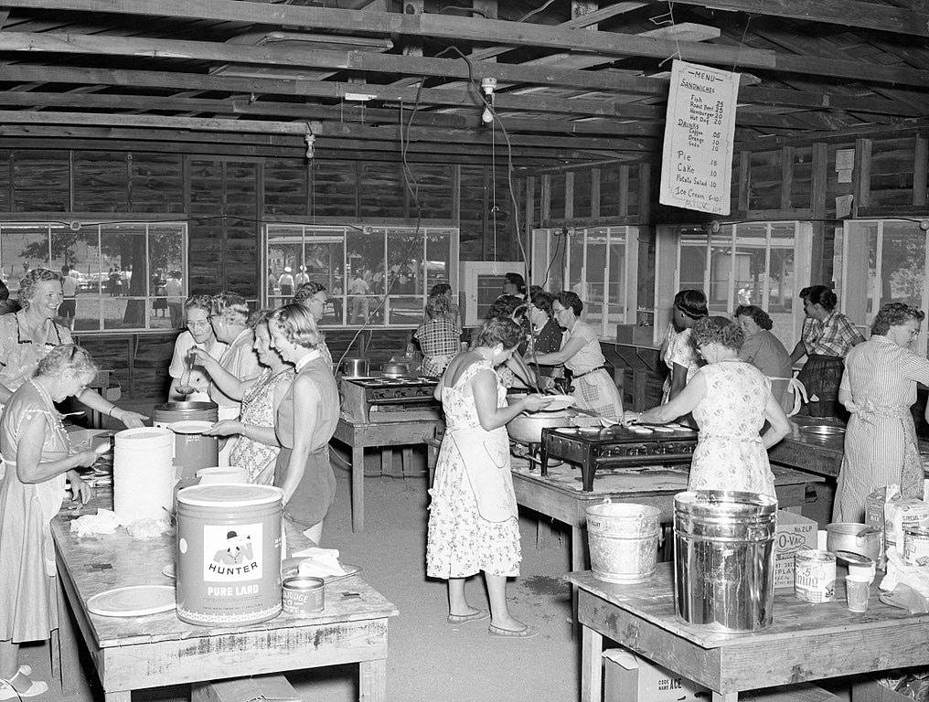 Women cooking in a large cabin, Missouri, 1956