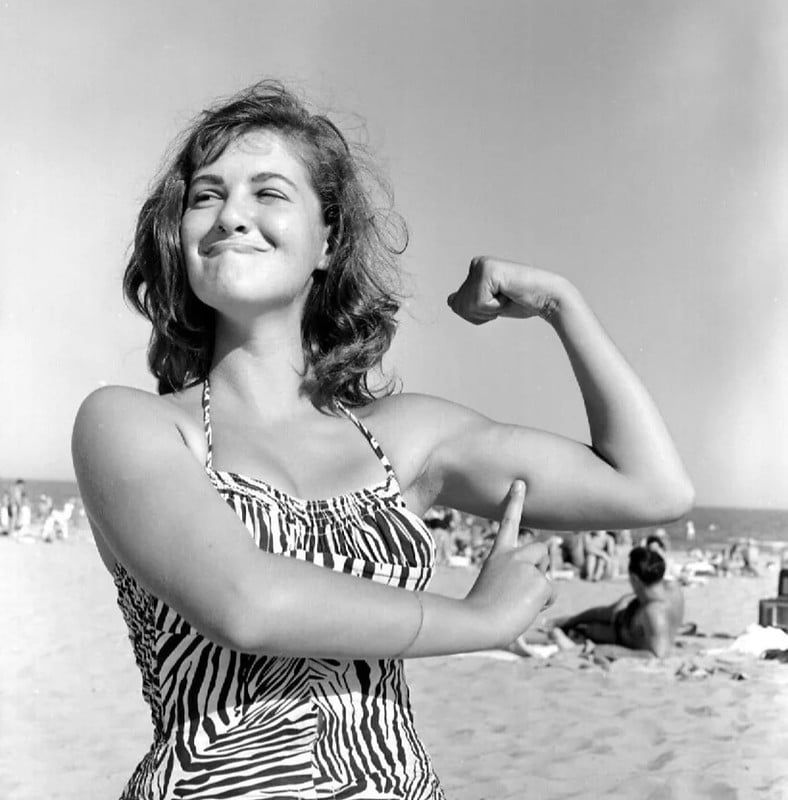 1950s Pretty Beach Brunette Flexing Muscles