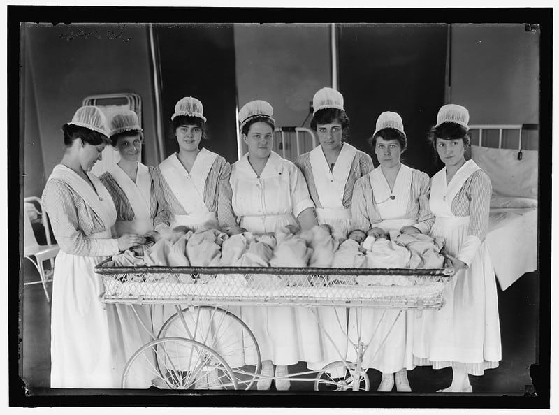 Nurses holding babies, early 20th century