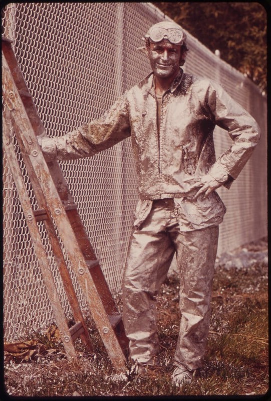 Painter Working on Chain Link Fence