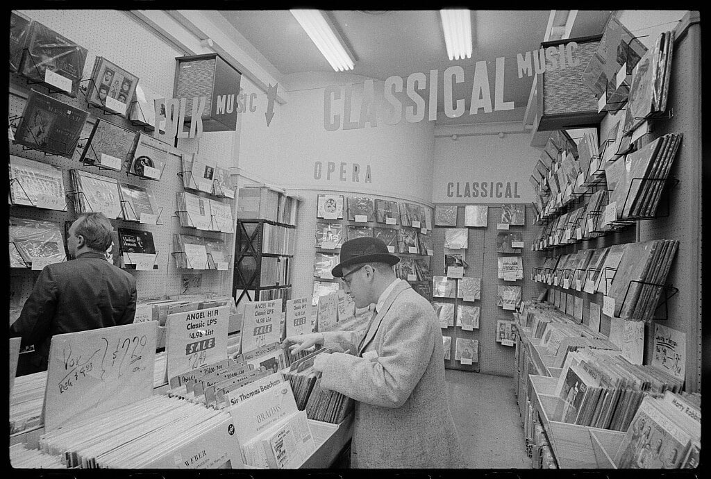Man looking through bins of records at a record store (20 March 1963)