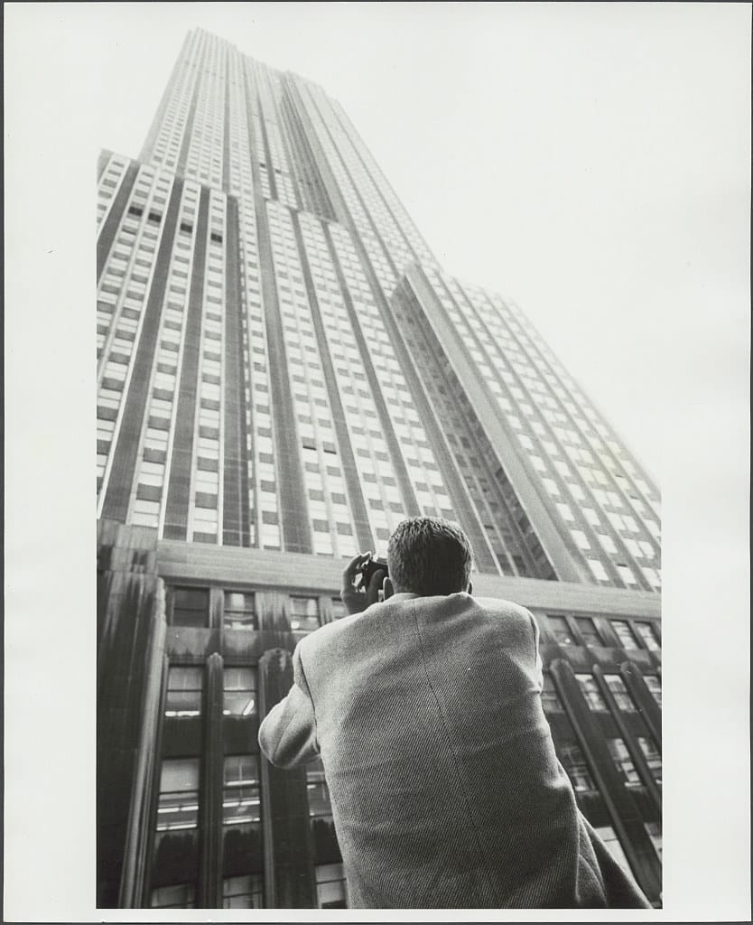 Man taking photo of Empire State Building, 1959