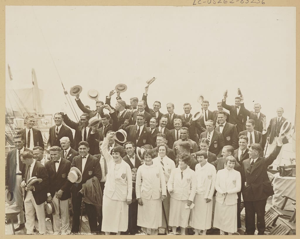 Victorious Olympic team members return aboard the S.S. America- Photograph shows a group portrait of team members standing on ship upon their arrival from Paris, France. (5 August 1924)