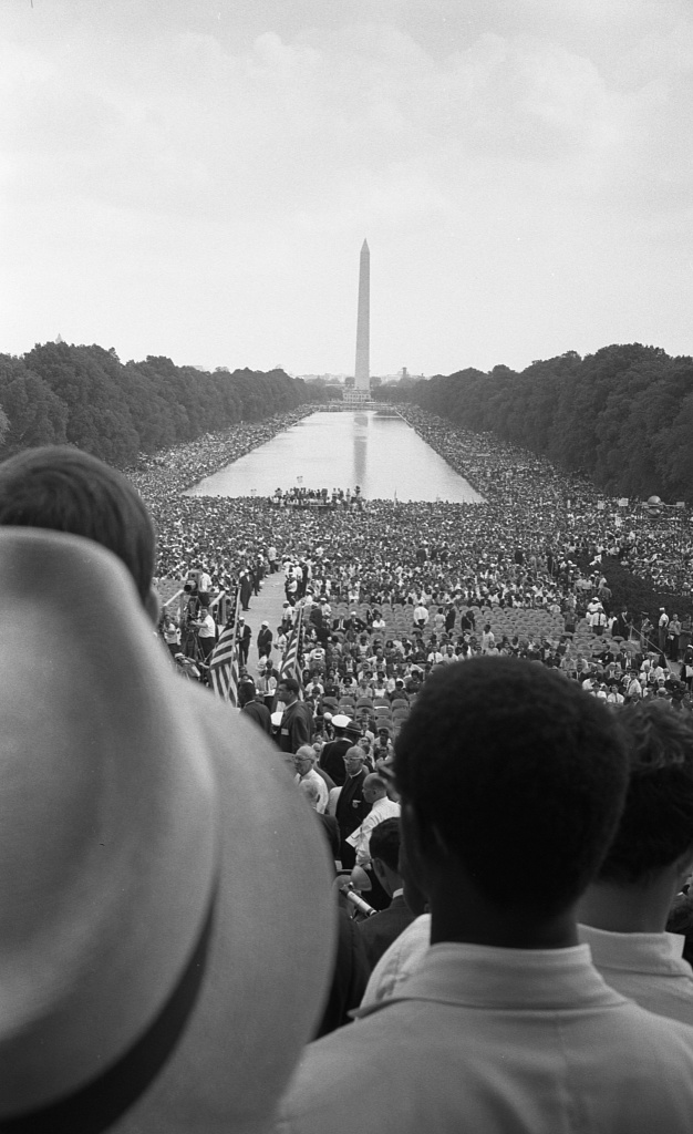 Civil rights march on Washington, D.C. — Photograph shows a crowd of African Americans and whites surrounding the Reflecting Pool and continuing to the Washington Monument. (1963 Aug. 28)