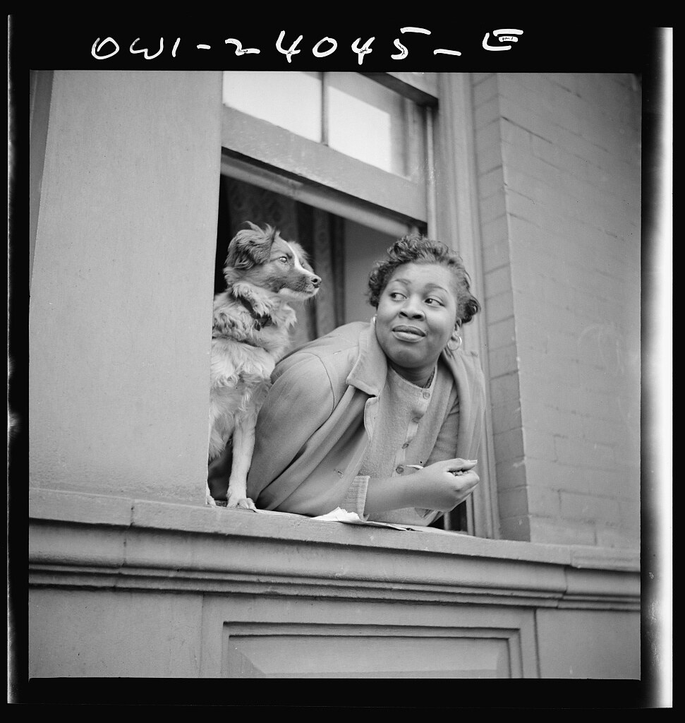 New York, New York. A woman and her dog in the Harlem section (1943 May)