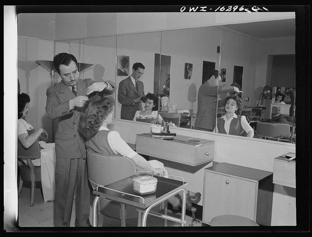 Photograph appears to show two women getting their hair styled before a fashion show at the Chrysler Girls' Club of the Chrysler Corporation at Saks Fifth Avenue store in Detroit, Michigan (Taken circa 1935)