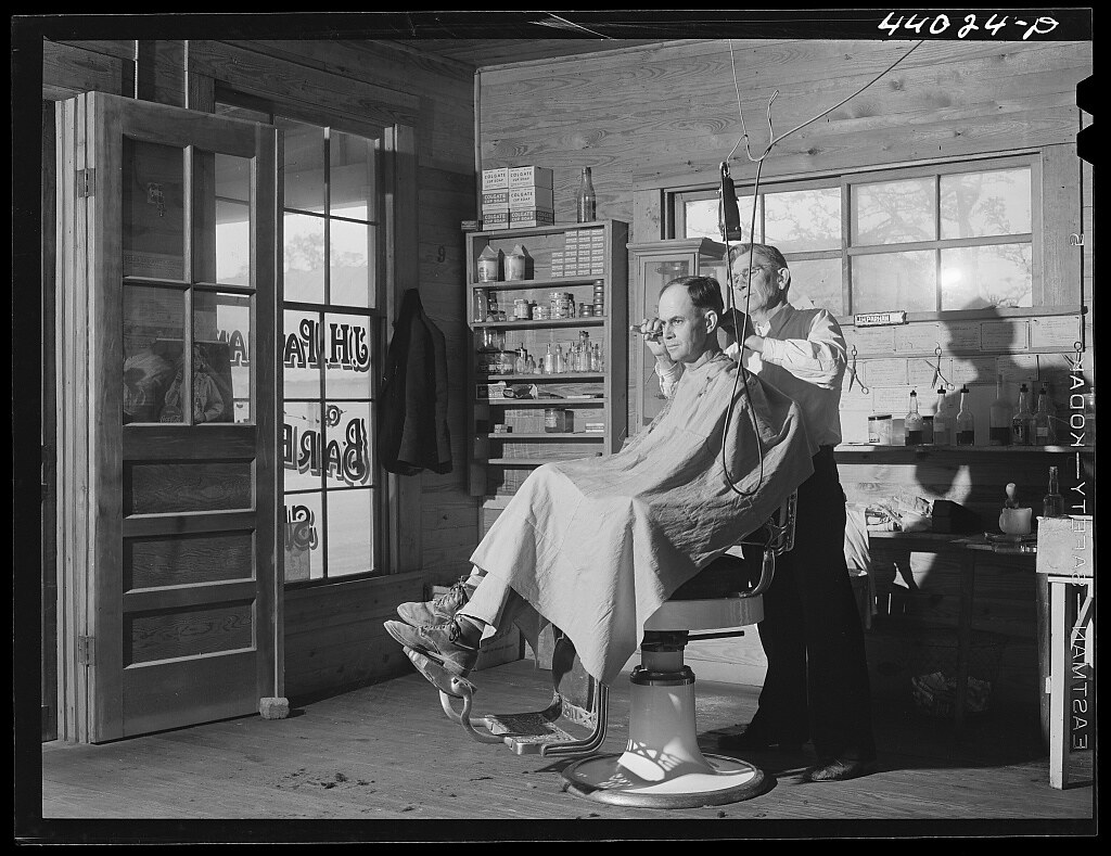 Mr. J. H. Parham, barber and notary public, in his shop in Centralhatchee, Heard County, Georgia (1941 Apr.)