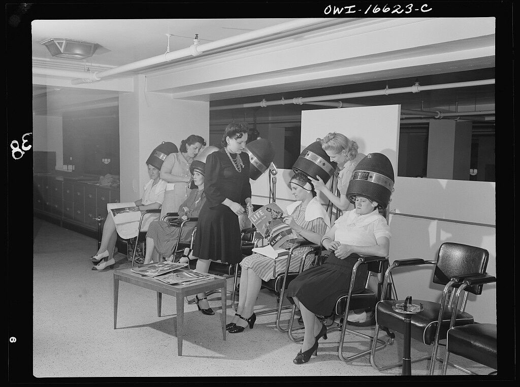 Detroit, Michigan. Women drying their hair in the beauty shop at the Crowley-Milner department store (1941 July)