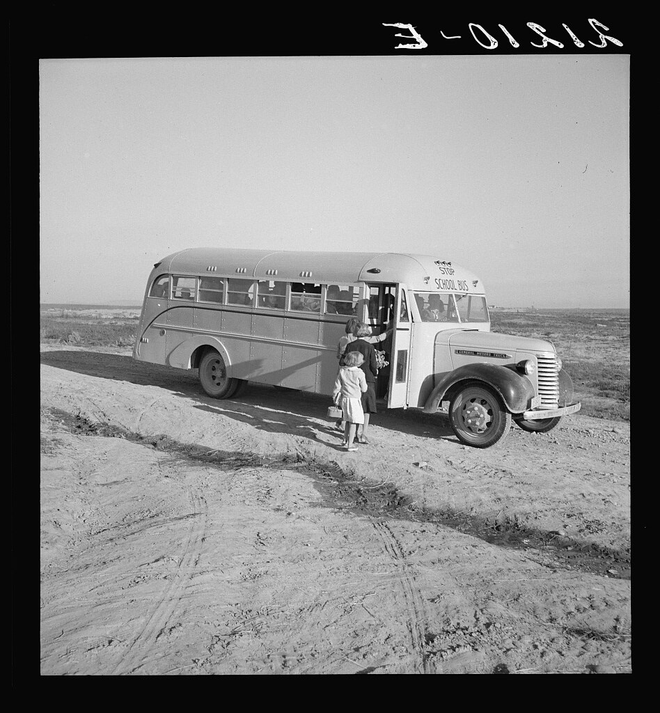 Dead Ox Flat. Children get into the school bus on a fall morning. Malheur County, Oregon. General caption number 67-1V (1939 Oct.)