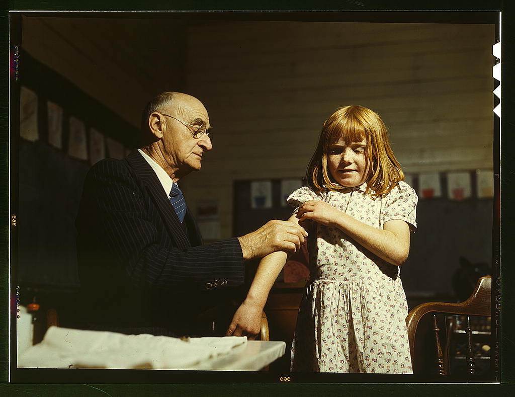 Dr. Schreiber of San Augustine giving a typhoid inoculation at a rural school, San Augustine County, Texas (1943 April)