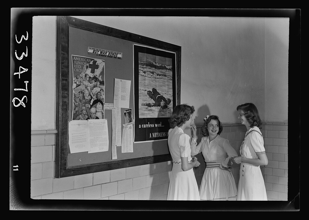 Keysville, Virginia. Randolph Henry High School. Girls in the entry hall talking before school in the morning. Bulletin board on wall (1943 June)