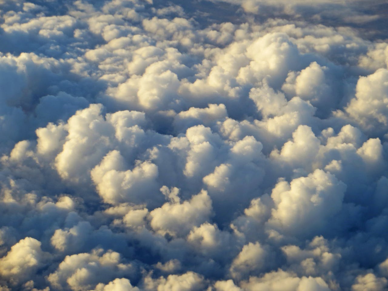 Clouds clustered, resembling cotton balls.