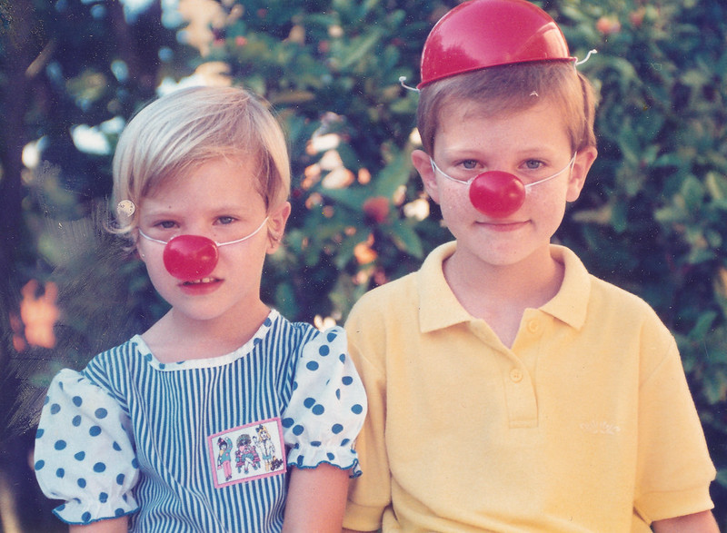 two kids wearing two red balls on their nose to resemble a red nose