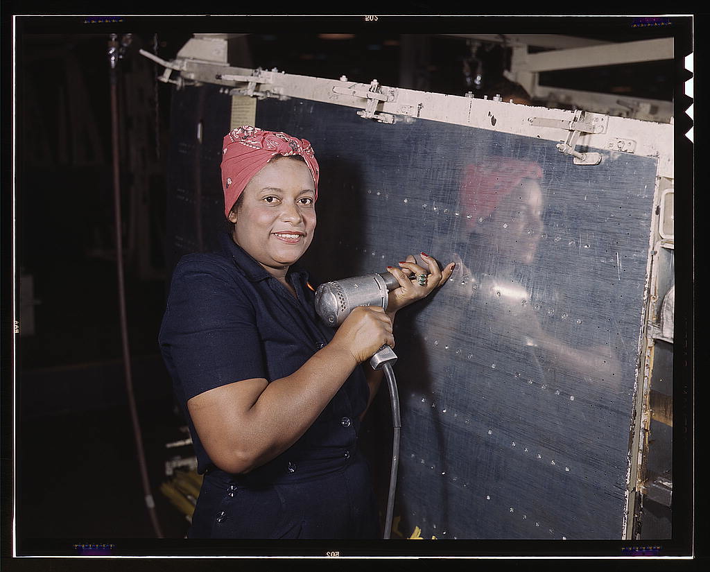 Woman using hand drill on Vengeance dive bomber