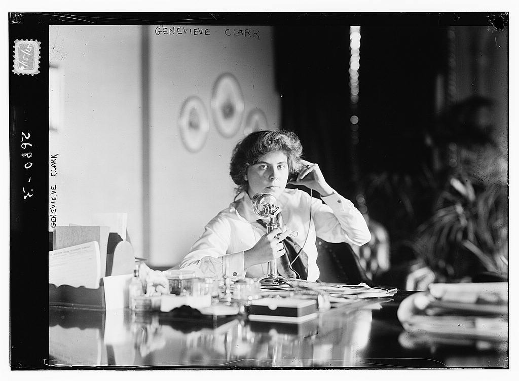 Genevieve Clark using an early telephone