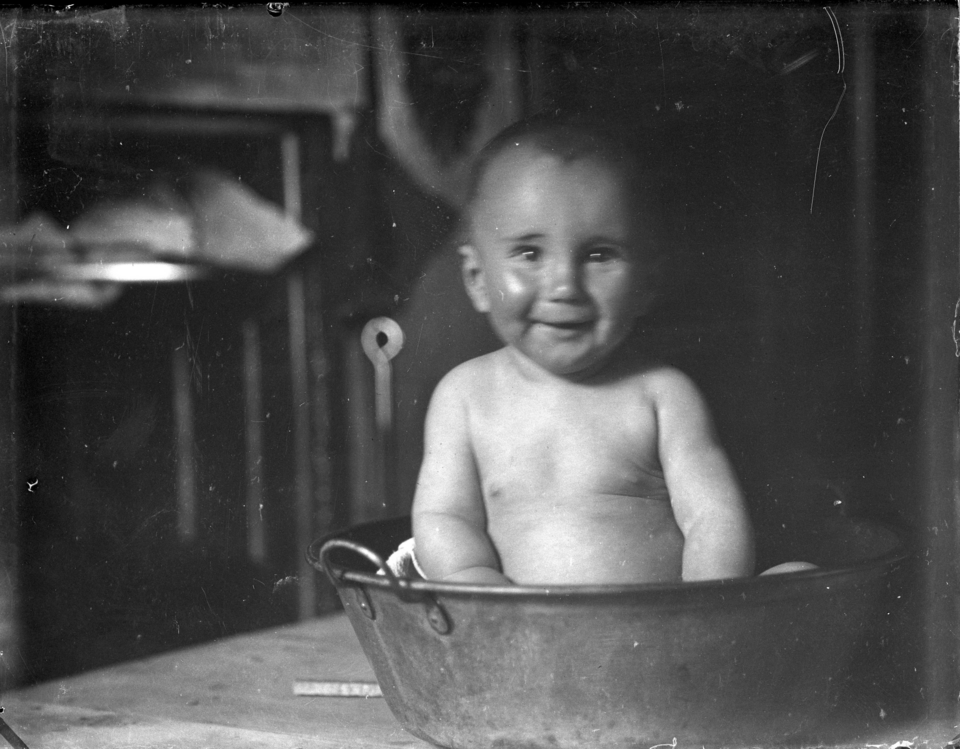Baby in tin tub bathing