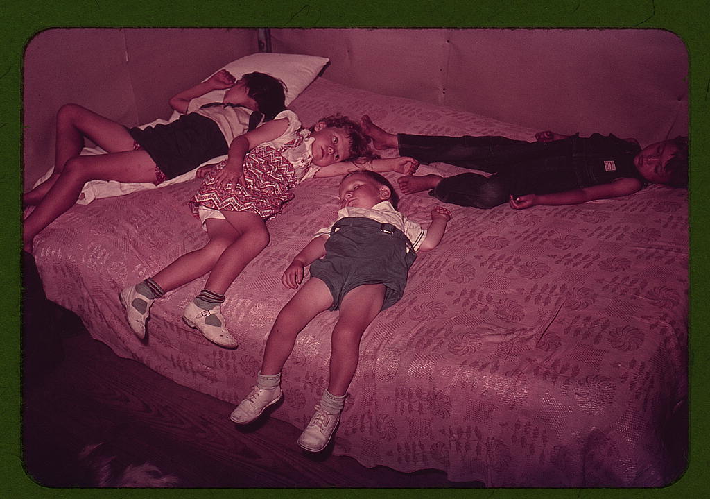Children asleep on bed during square dance, McIntosh County, Okla. (1939 or 1940)