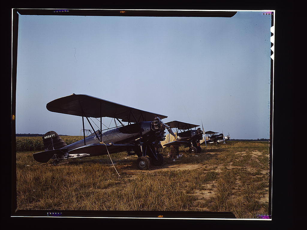 Low flying planes from which dust or insecticide is spread onto crops by men who ‘follow the season’ up the east coast, Seabrook Farm, Bridgeton, N.J. (1942 June)
