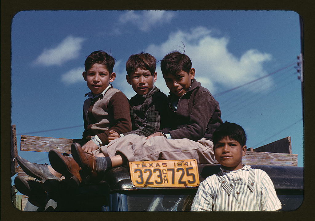 Boys sitting on trucks parked at the FSA labor camp, Robstown, Tex. (1942 Jan.)