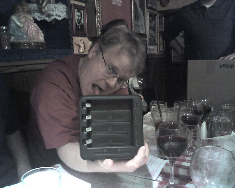A man showing off a Tupperware in a Greek dinner/tupperware party, 2007