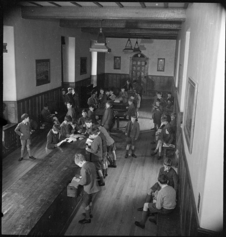 Catholic Public School- Everyday Life at Ampleforth College, York, England, UK, 1943. Boys are in their uniforms while browsing through books