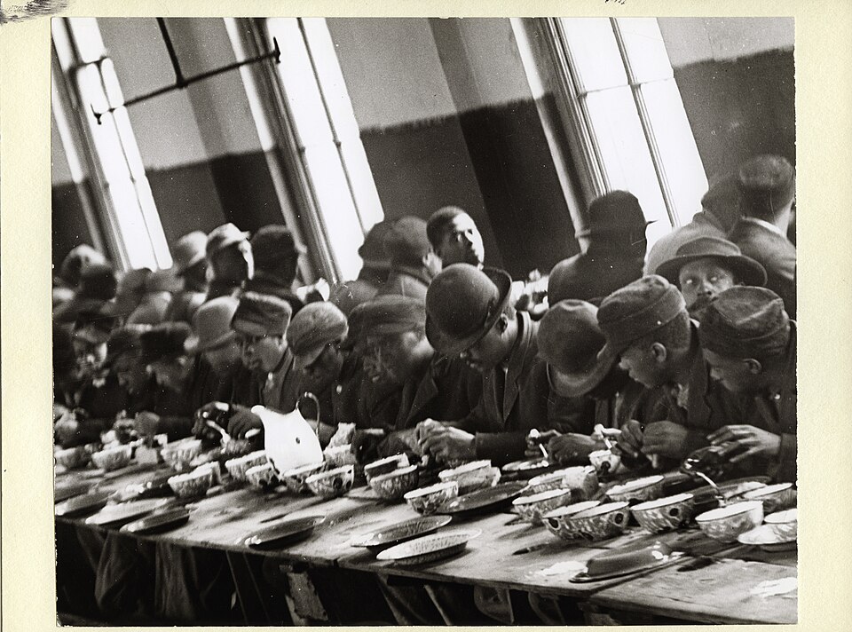 African-American men eating at soup kitchen c1913