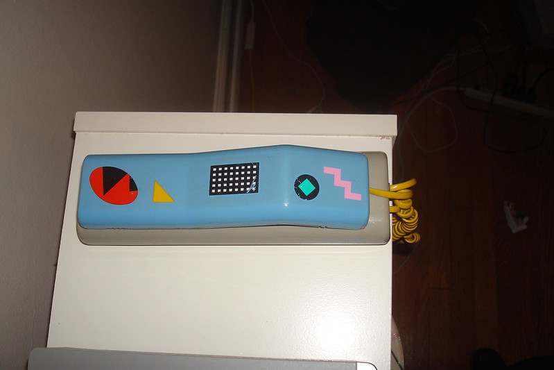 A swatch phone that is put in the 80s living room