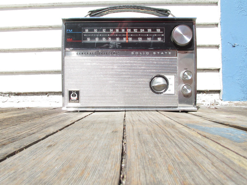 Transistor tabletop portable. Classic slide rule dial. Displayed in US living rooms