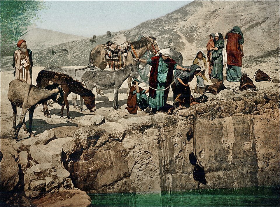 Bedouin women drawing water, desert, circa 1900