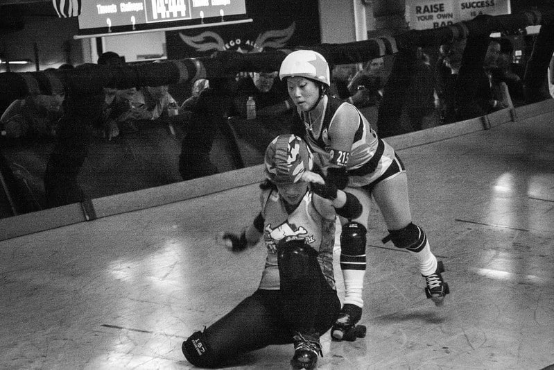 Two roller skaters bumping into each other during the Diego Rollers vs Hard Corps Championship Match