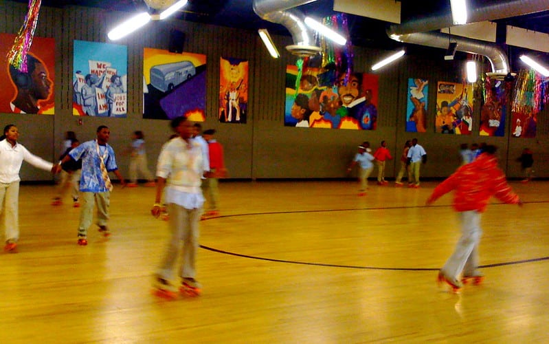 Children roller skating at a colorful rink
