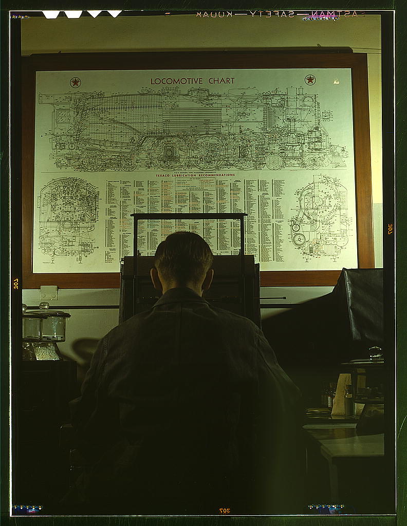 Locomotive lubrication chart in the laboratory of the Chicago and Northwestern Railroad. The laboratory assistant in the foreground is working at a precision balance. Chicago, Ill (1942 Dec.)