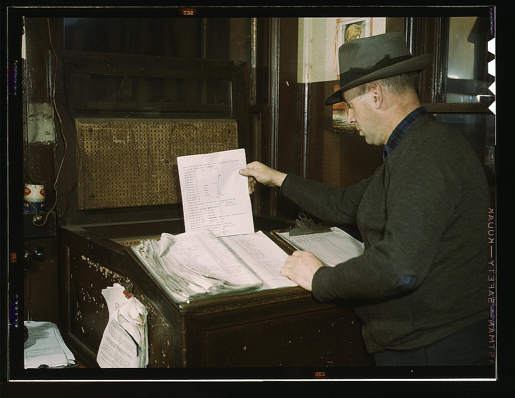 Switch lists coming in by teletype to the hump office at a Chicago and Northwestern railroad yard, Chicago, Ill. (1942 Dec.)
