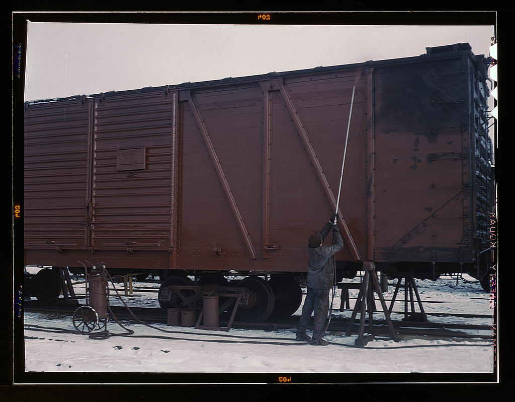 Painting a car at the repair or ‘rip’ tracks at North Proviso, C & NW RR., Chicago, Ill. (1942 Dec.)