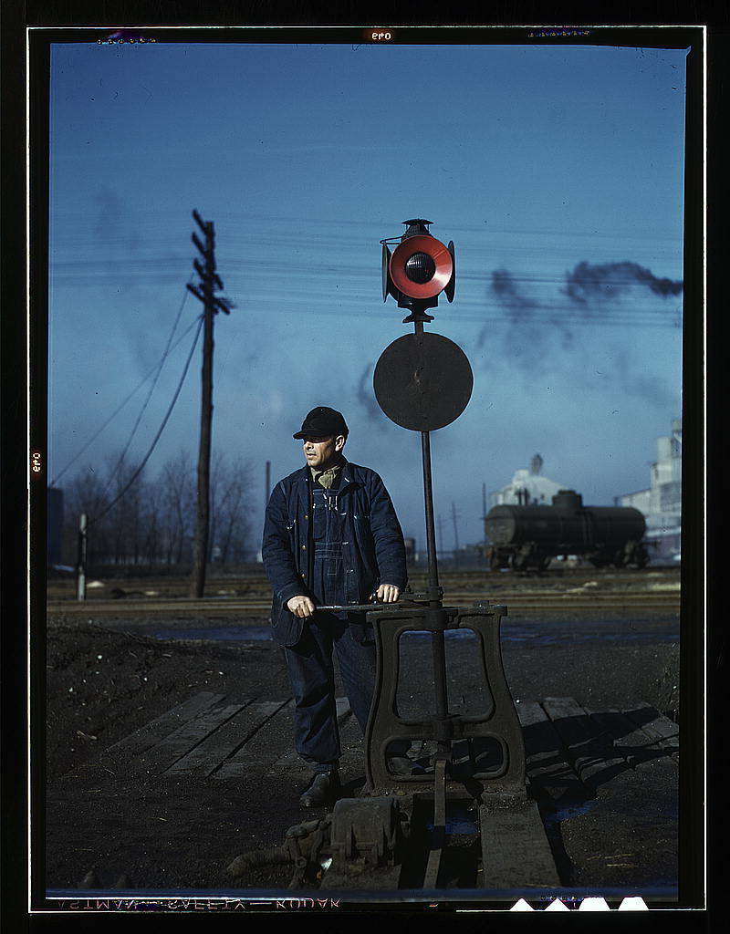 Daniel Senise throwing a switch while at work in an Indiana Harbor Belt Line railroad yard (1943 Feb.)