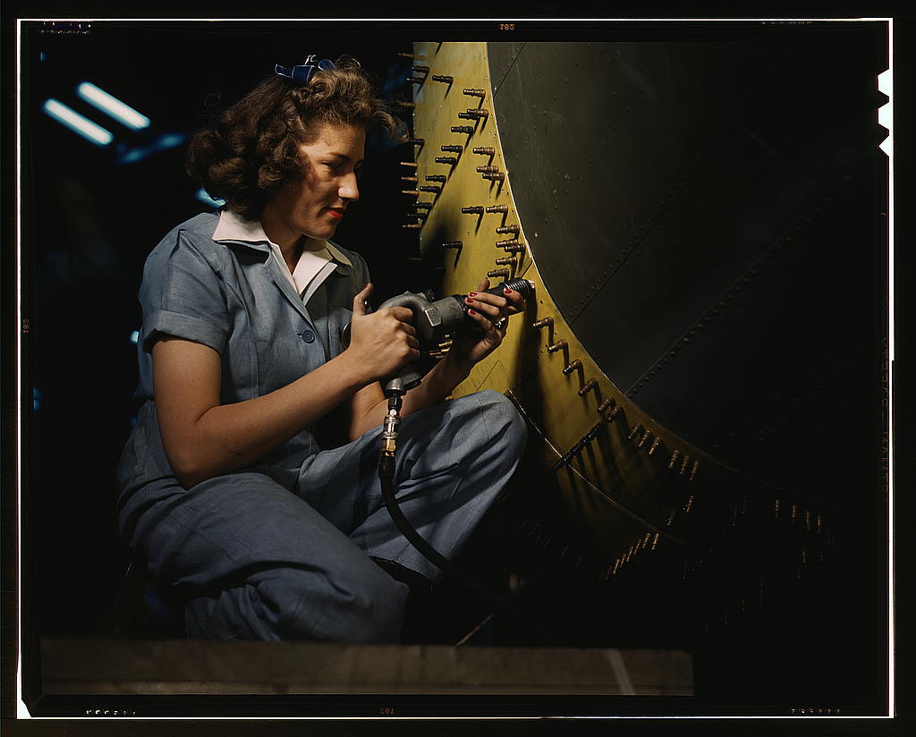 Riveter at work on Consolidated bomber, Consolidated Aircraft Corp., Fort Worth, Texas (1942 Oct.)