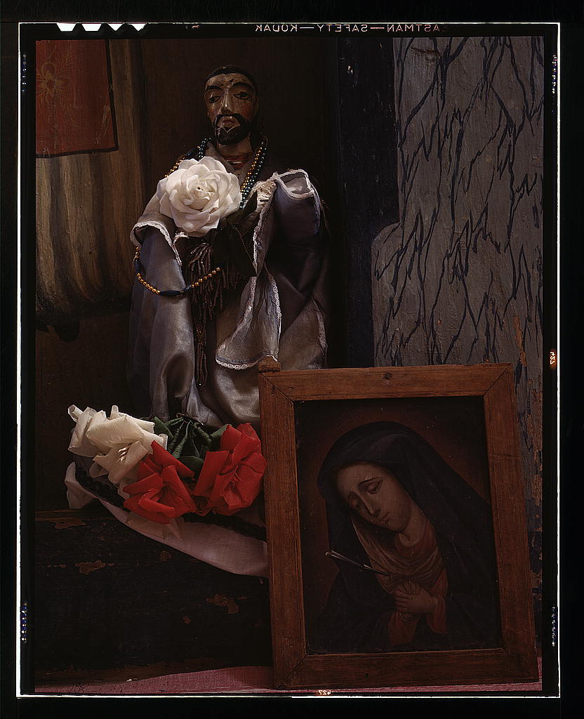 A Santo bulto and a painting of the Dolorosa in the church, Trampas, New Mexico (1943 Spring)
