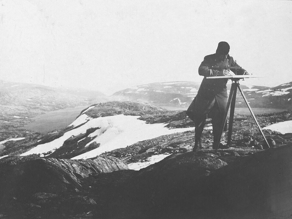 Land surveyor using early instruments, c. 1906