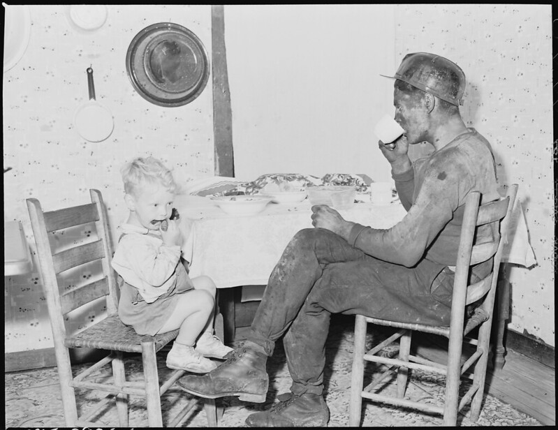 Rufus Sergeant and his son eating after a day in the mines.