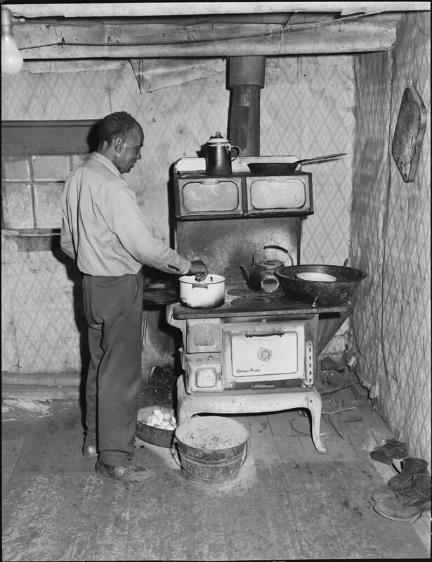 Joshua Spradley cooking in his two-room garage house.