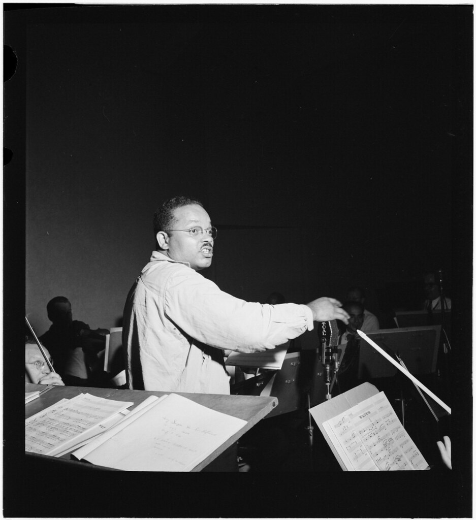 Sy Oliver beams in studio, baton poised, New York, 1946