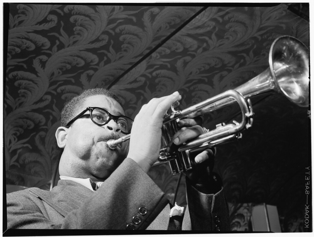 Dizzy Gillespie, smiling and holding trumpet, New York, 1947