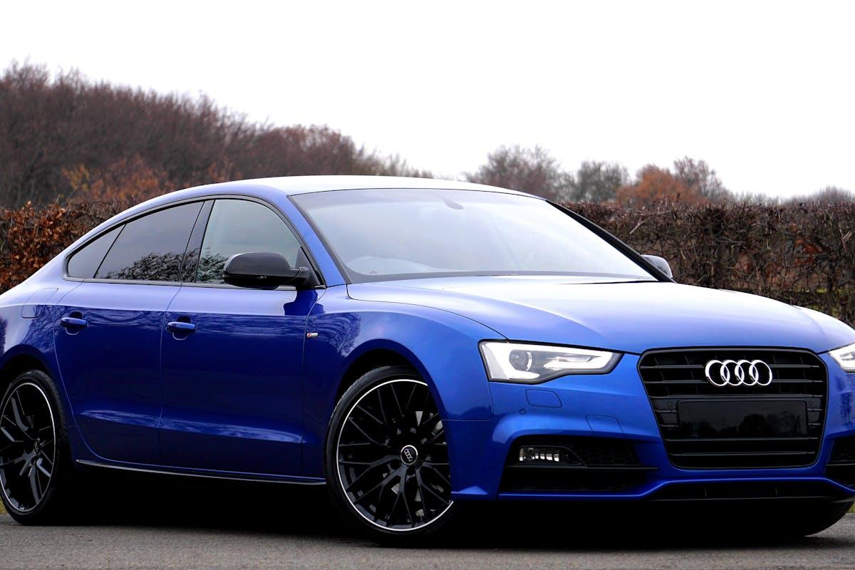 A blue car parked on the road AI-generated content may be incorrect.